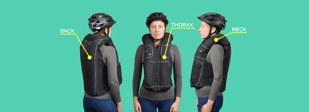 Cyclist wearing the Black B'Safe safety cycling vest, front view protected areas